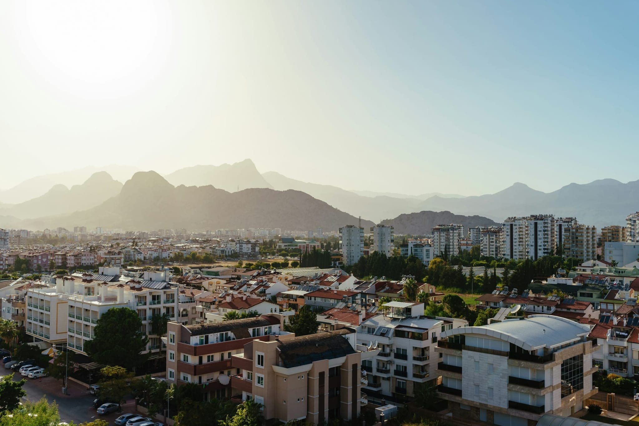 Antalya from above: the roofs of Konyaaltı with the Taurus Mountains in hazy backlight.