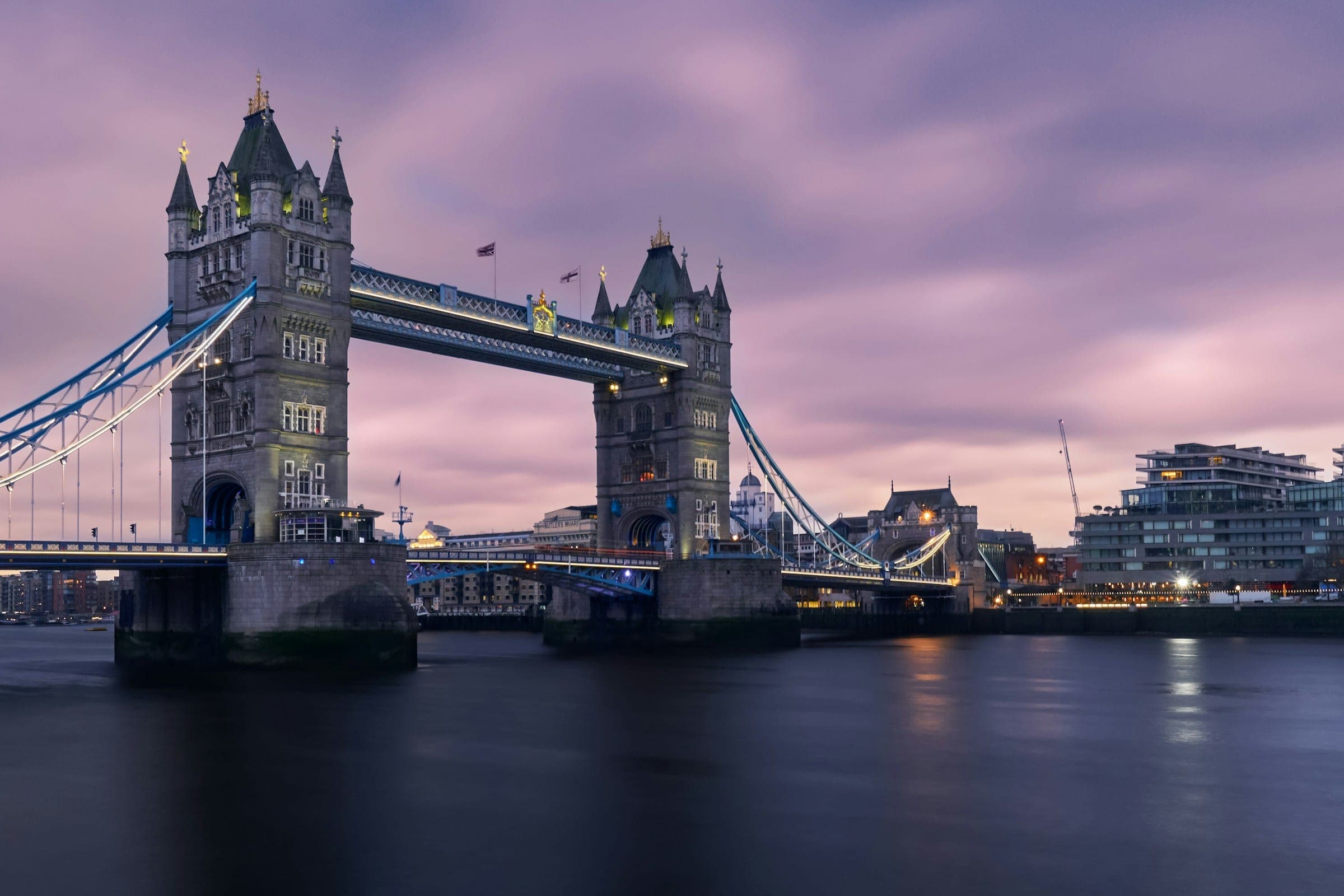 Tower Bridge in de schemering, met de verlichte torens boven de Theems.